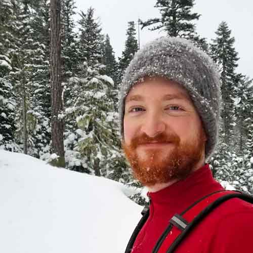 Simon Fraher standing on cold wintery mountain